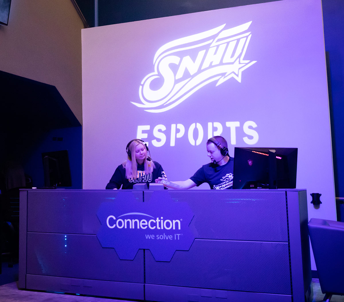 announcers sitting up front at SNHU esports complex