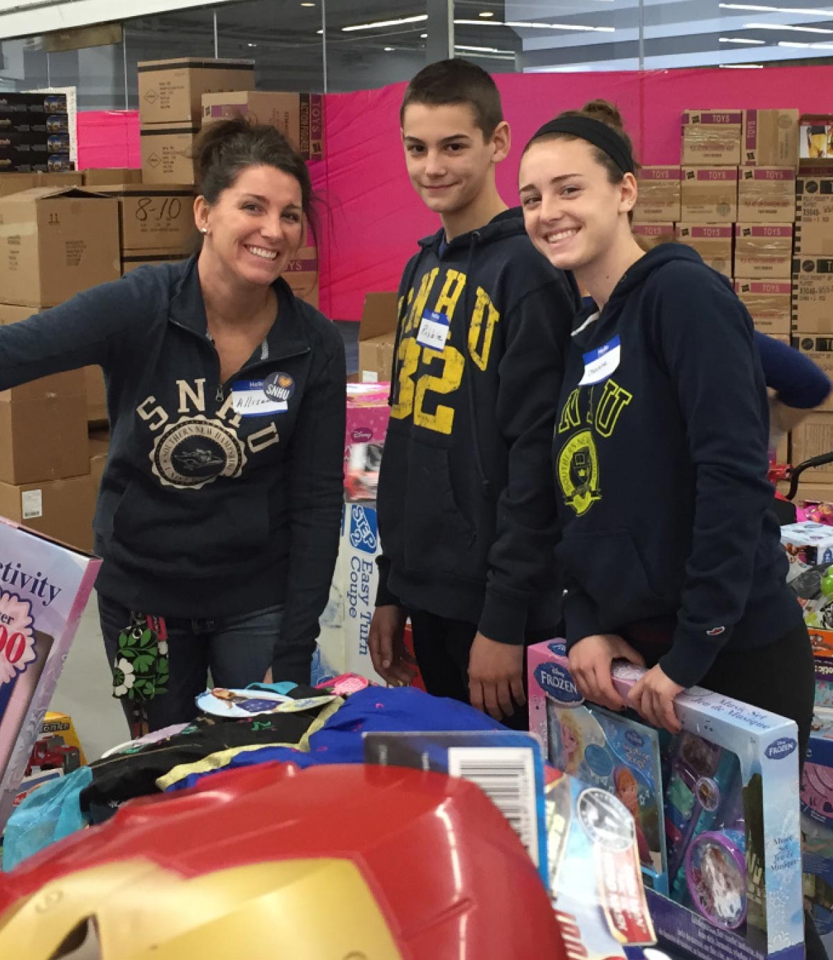 Allison Nichols and her two kids helping organize toys at the Salvation Army Toy Shop