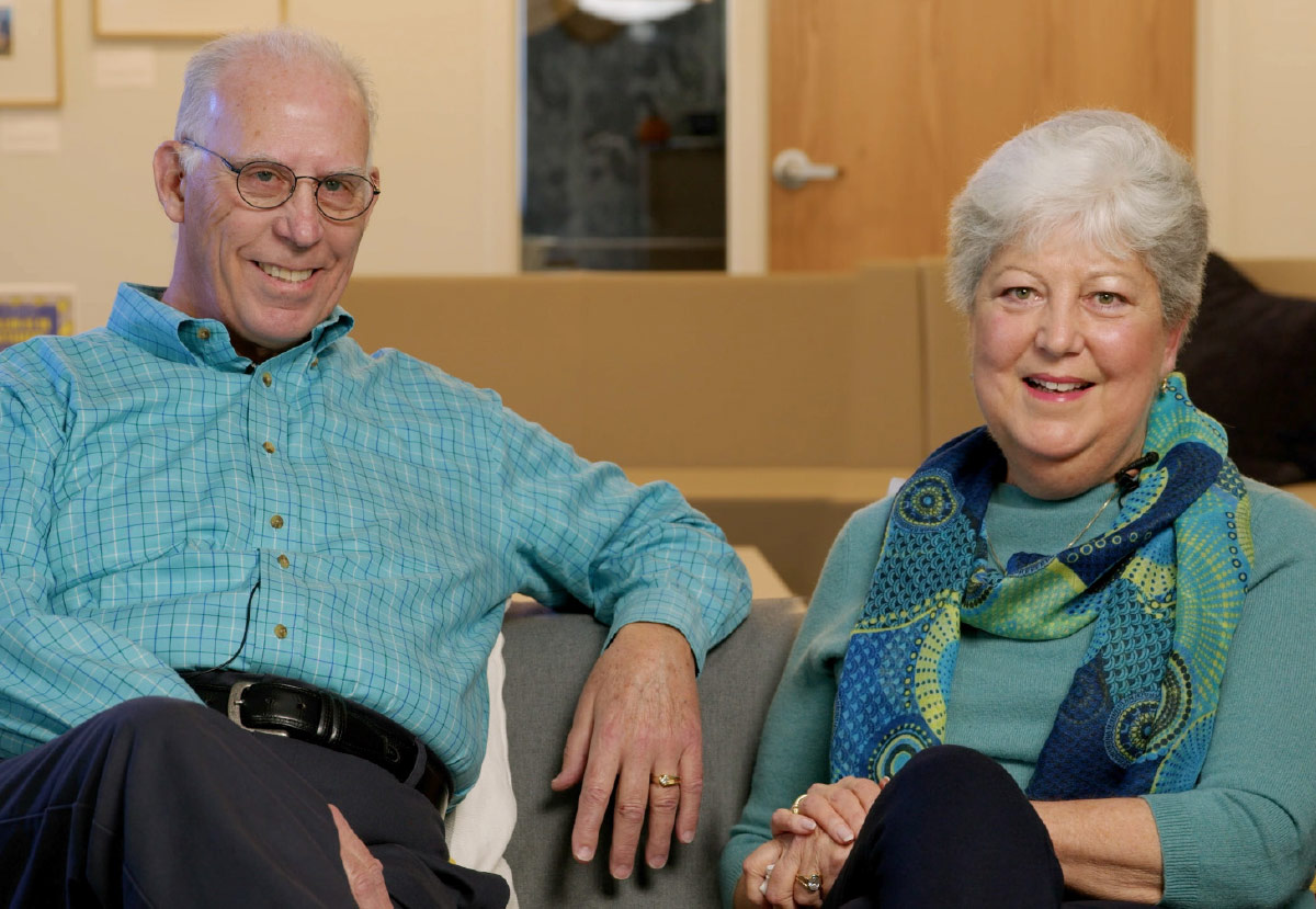 Laurie and Clark Chandler sitting on sofa together and smiling