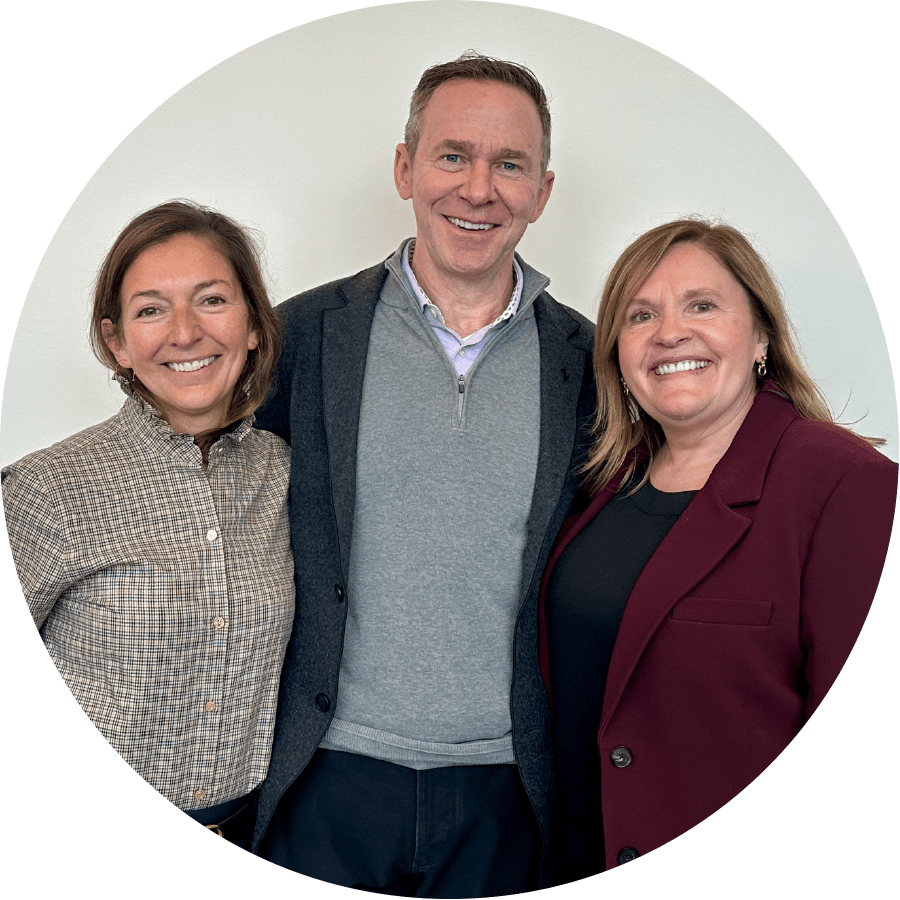 Jim Chilton smiling with two female colleagues